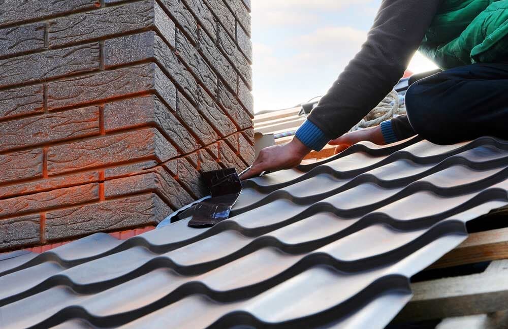 Metal shingles being installed by an expert roofer